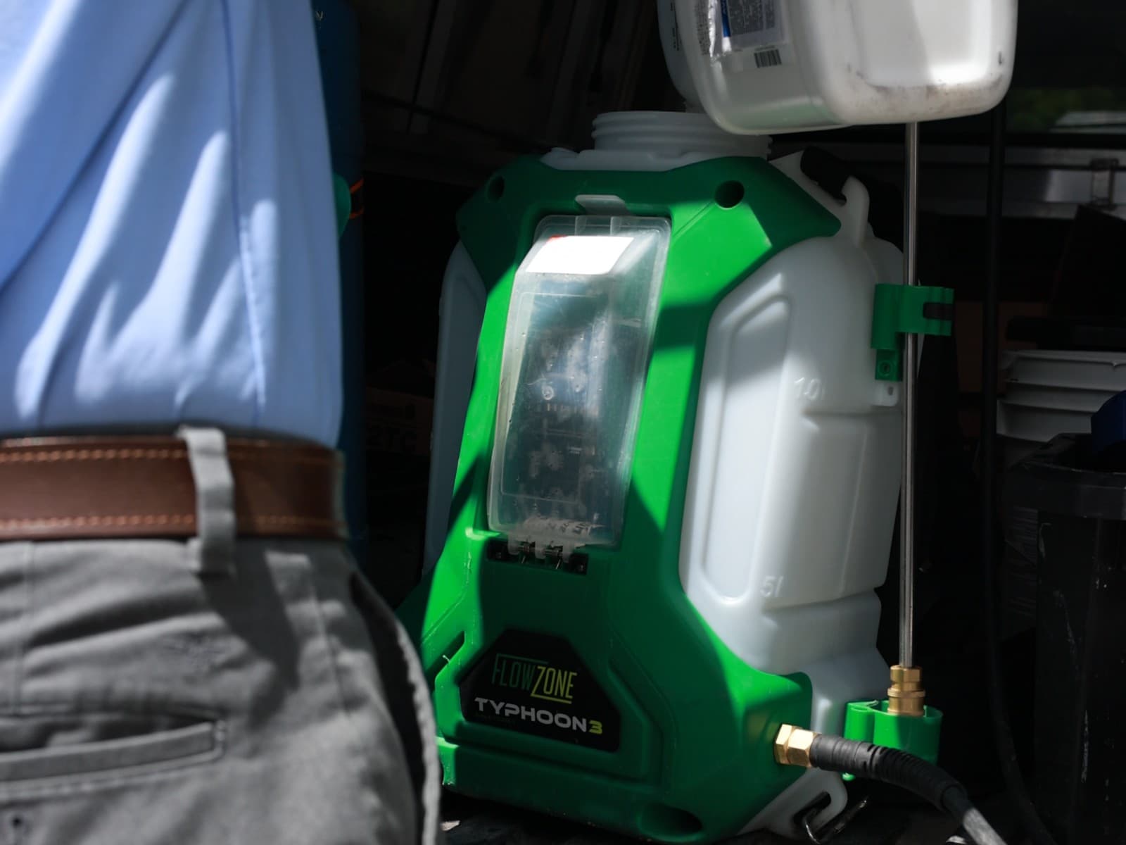 Peak Pest Control technician refilling a FlowZone sprayer for a residential visit